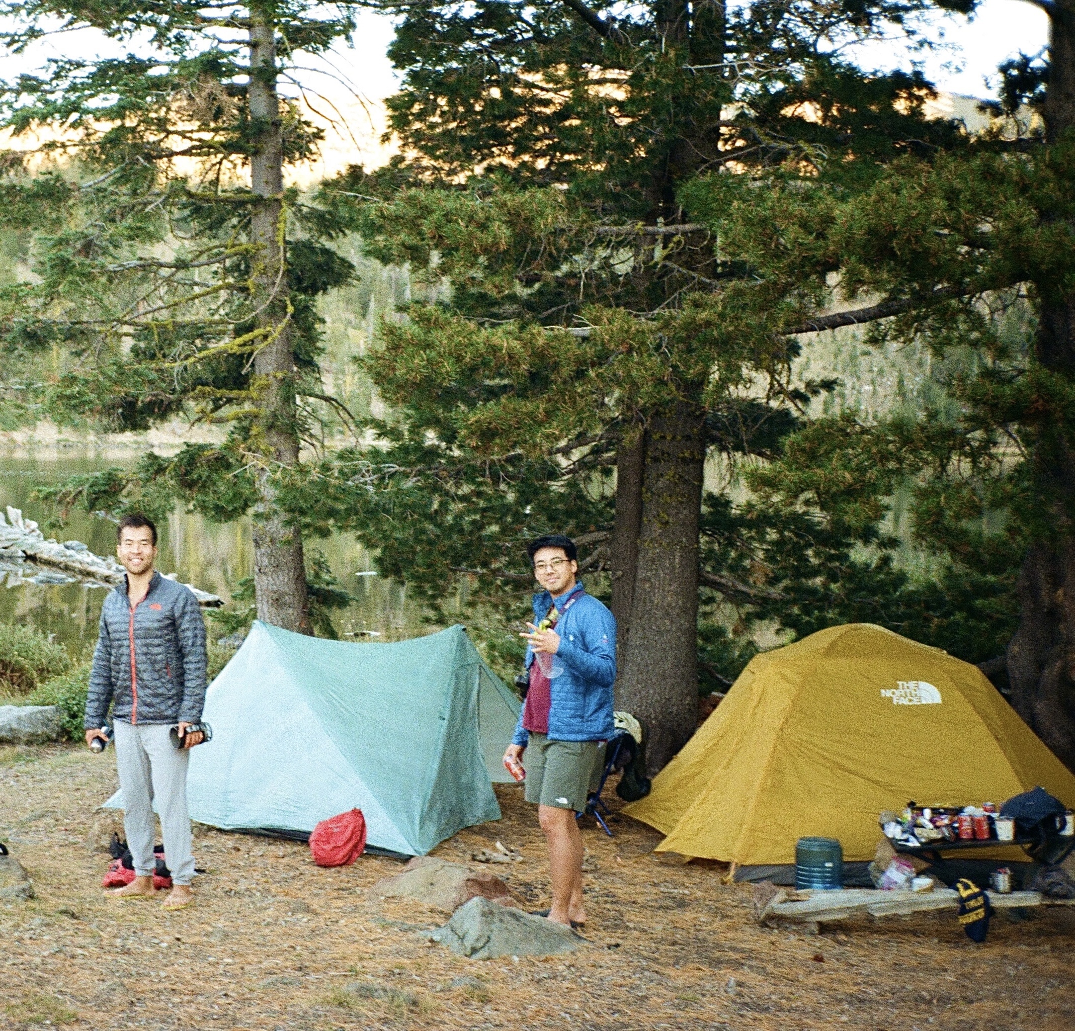 matt and geo at a backcountry campsite by a lake at dusk